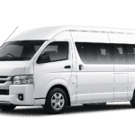Toyota Hiace Commuter putih tampak serong depan dan samping untuk layanan sewa Hiace Bandung dengan driver profesional