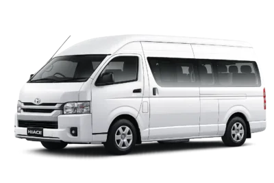 Toyota Hiace Commuter putih tampak serong depan dan samping untuk layanan sewa Hiace Bandung dengan driver profesional