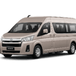 Toyota Hiace Premio coklat muda metallic tampak serong depan dan samping untuk layanan sewa Hiace Bandung dengan driver profesional