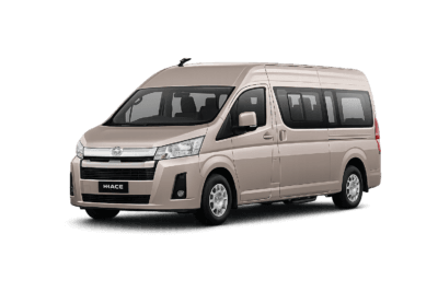 Toyota Hiace Premio coklat muda metallic tampak serong depan dan samping untuk layanan sewa Hiace Bandung dengan driver profesional