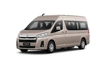 Toyota Hiace Premio coklat muda metallic tampak serong depan dan samping untuk layanan sewa Hiace Bandung dengan driver profesional